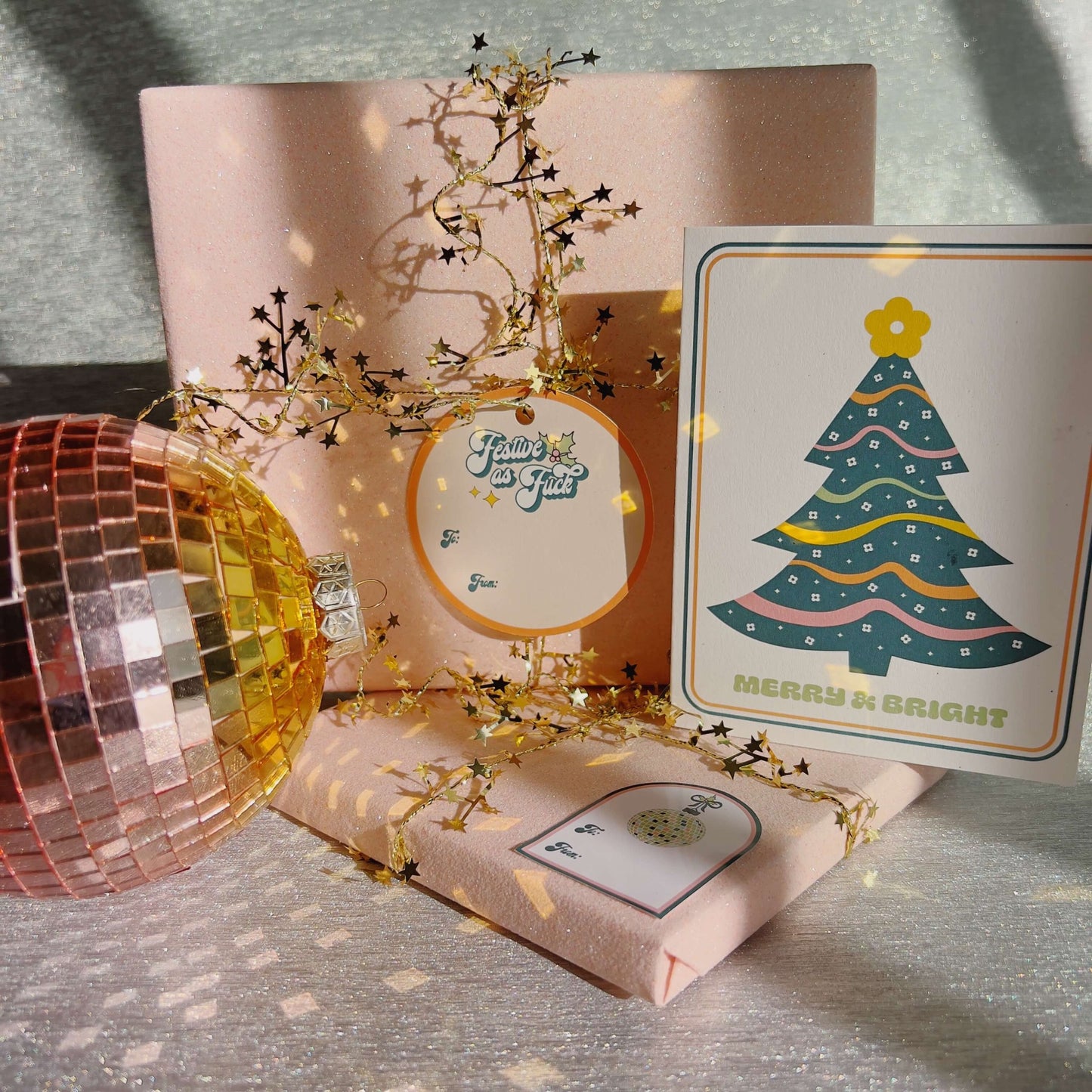 christmas gifts wrapped in pink glitter wrapping paper with disco ball ornaments