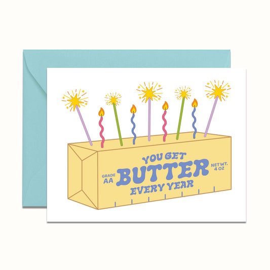 Greeting card with a stick of butter and colorful candles on a white background. Graphic reads "You get butter every year"