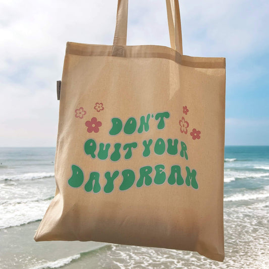 Don't quit your daydream tote bag in front of ocean