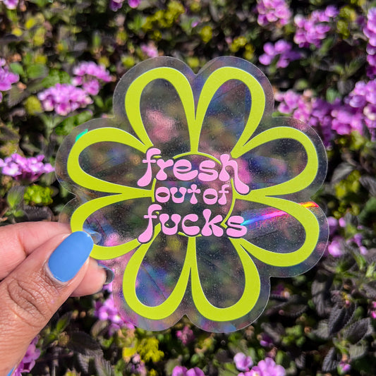 fresh out of fucks rainbow suncatcher decal in front of flower bush