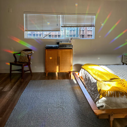 bedroom with rainbow sun rays through window